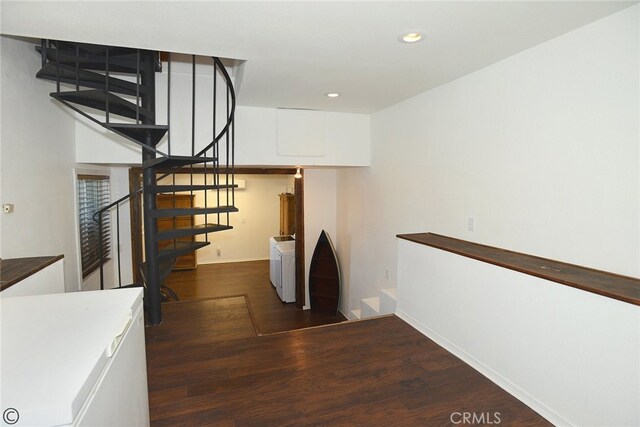 stairs featuring wood-type flooring and washer / clothes dryer