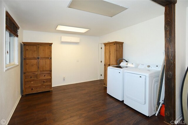 laundry area featuring a wall mounted AC, cabinets, washer and clothes dryer, and dark wood-type flooring