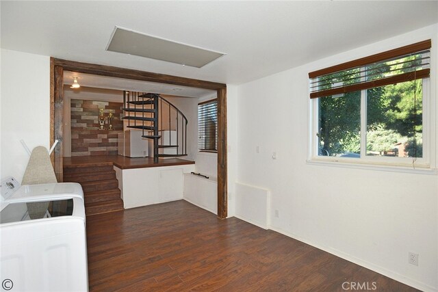 interior space with washing machine and dryer and dark hardwood / wood-style floors