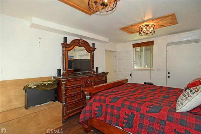 bedroom with dark wood-type flooring and a wall mounted air conditioner