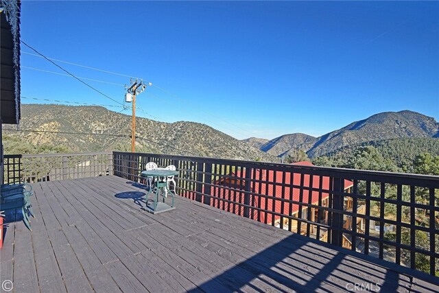 wooden terrace with a mountain view