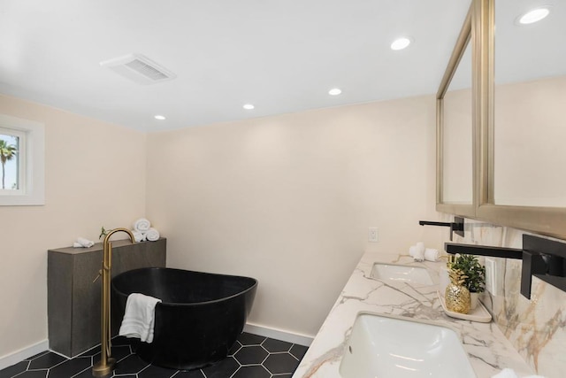 bathroom with a bathing tub and vanity