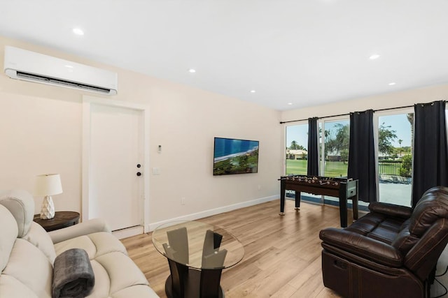 living room with light wood-type flooring and an AC wall unit