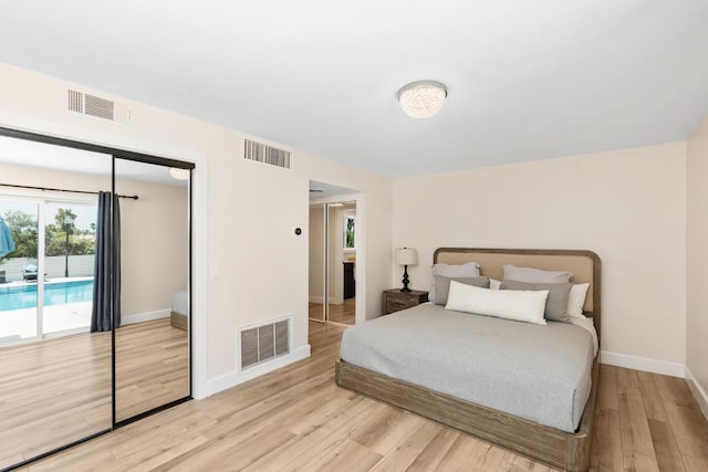 bedroom with light wood-type flooring, access to outside, and a closet