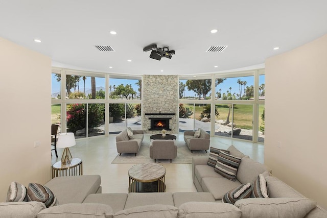 living room featuring expansive windows and a fireplace