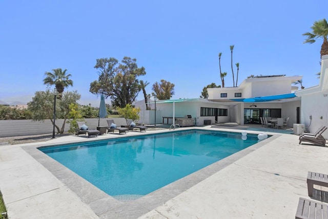 view of swimming pool with a patio area