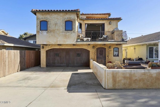 mediterranean / spanish house featuring a balcony and a garage