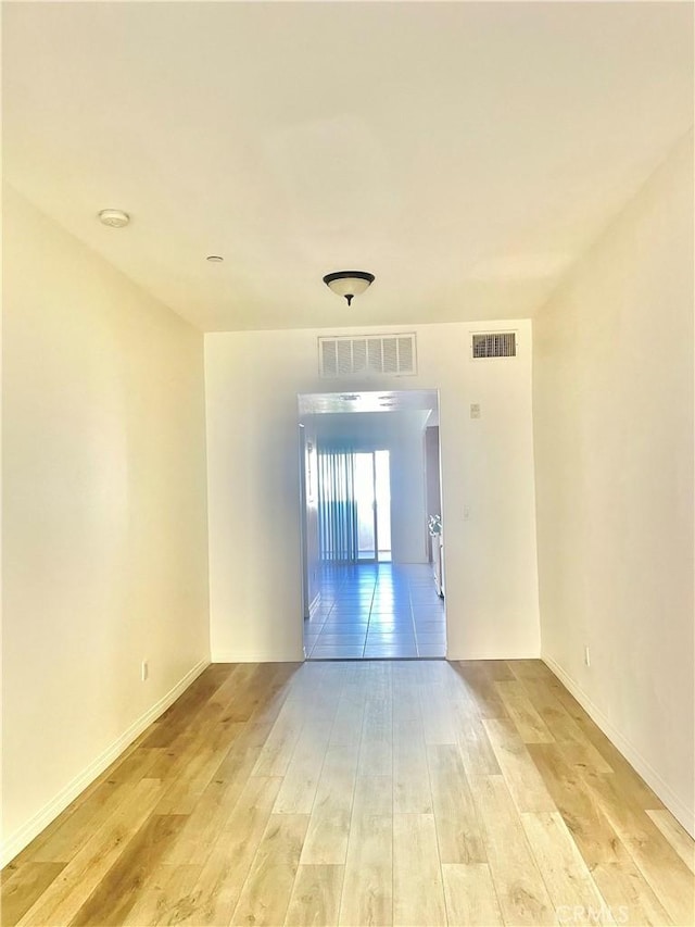 empty room with light hardwood / wood-style floors