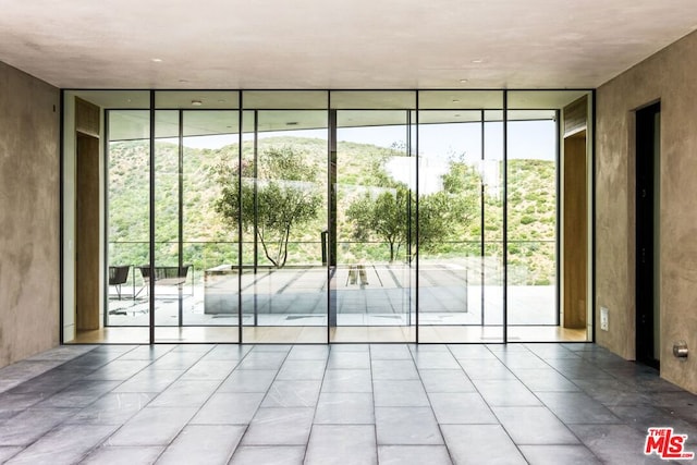 doorway to outside with expansive windows