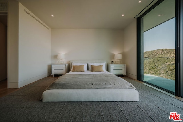 bedroom featuring access to outside and a mountain view