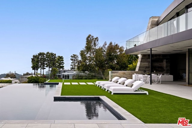 view of yard featuring a patio area and an outdoor bar