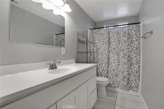 10590 Navajo Rd, Apple Valley, CA 92308 - full bath with marble look tile flooring, vanity, and toilet
