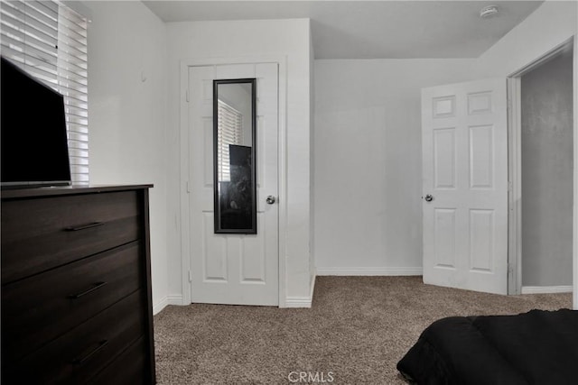 carpeted bedroom with baseboards