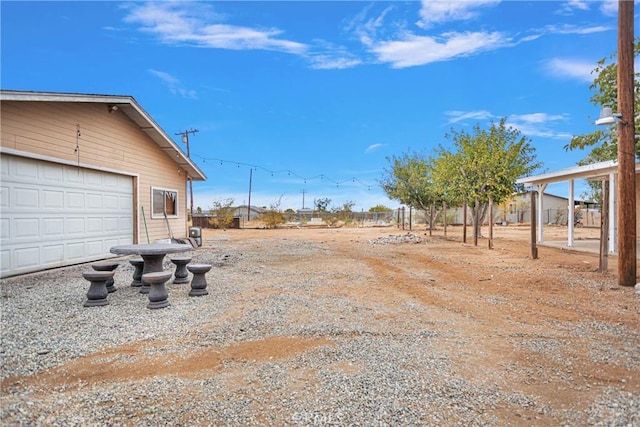 view of yard with a garage and fence