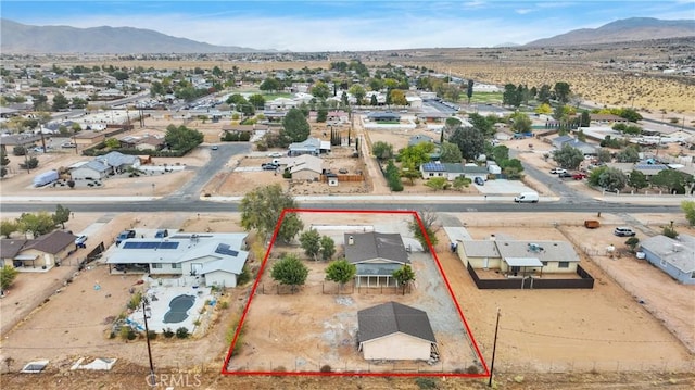 aerial view featuring a residential view, a desert view, and a mountain view