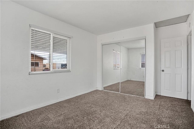 10590 Navajo Rd, Apple Valley, CA 92308 - unfurnished bedroom featuring carpet, multiple windows, a closet, and baseboards