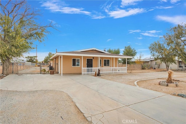 view of front of property with a porch and fence