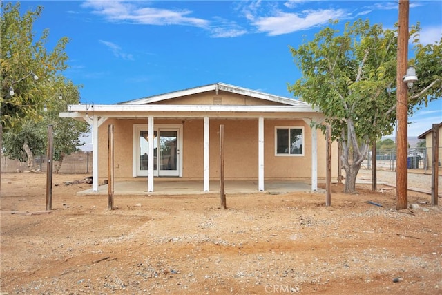 10590 Navajo Rd, Apple Valley, CA 92308 - rear view of property featuring stucco siding, fence, and a patio