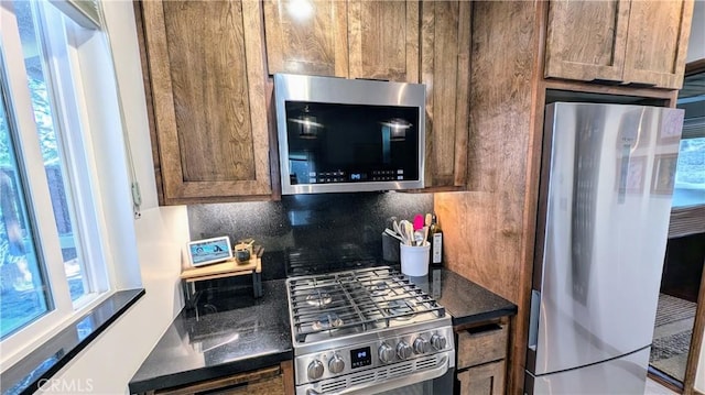 2552 Catalina Dr, Running Springs, CA 92382 - kitchen featuring dark countertops, backsplash, and appliances with stainless steel finishes