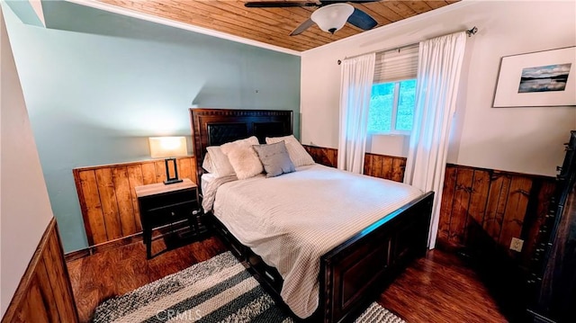 bedroom featuring crown molding, ceiling fan, dark wood-type flooring, and wood ceiling