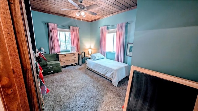 carpeted bedroom featuring ceiling fan and wood ceiling