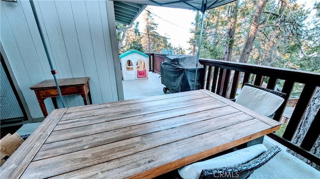 wooden deck featuring a grill