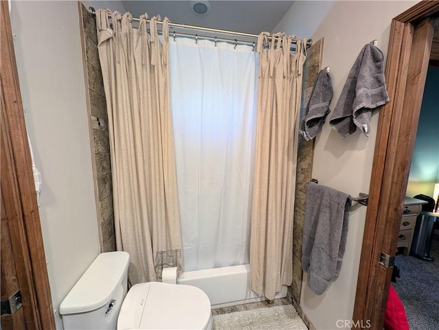 bathroom with shower / tub combo and toilet