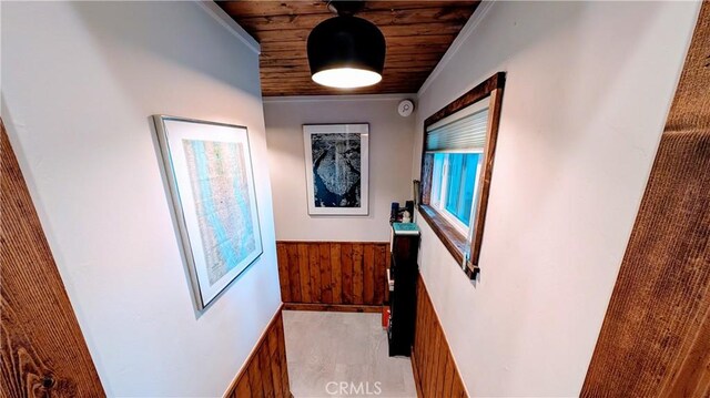 2552 Catalina Dr, Running Springs, CA 92382 - hallway with ornamental molding, wood walls, a wainscoted wall, and wooden ceiling