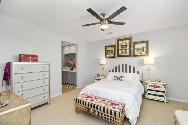 carpeted bedroom featuring ceiling fan and ensuite bathroom