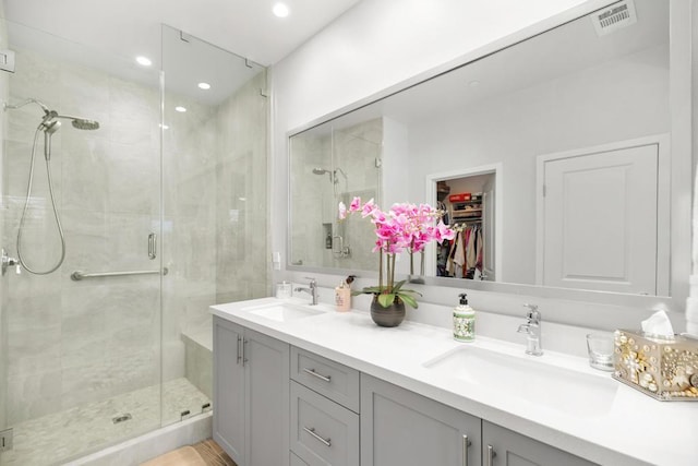 bathroom with vanity and a shower with shower door