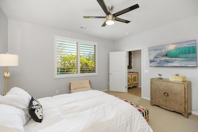 bedroom with ceiling fan and light colored carpet