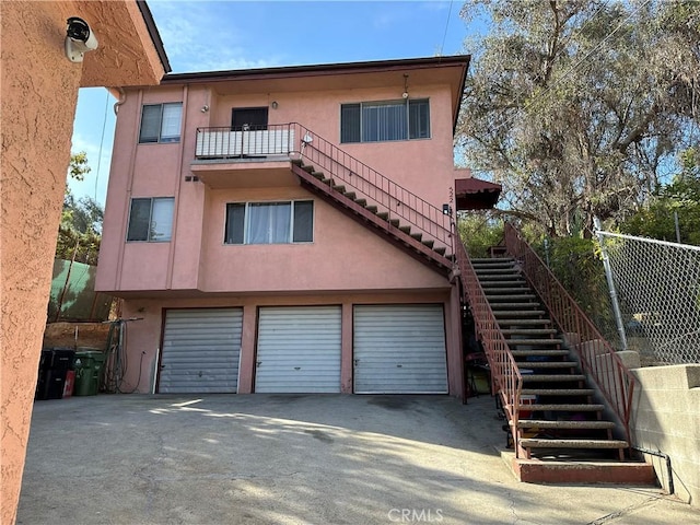 rear view of house featuring a garage