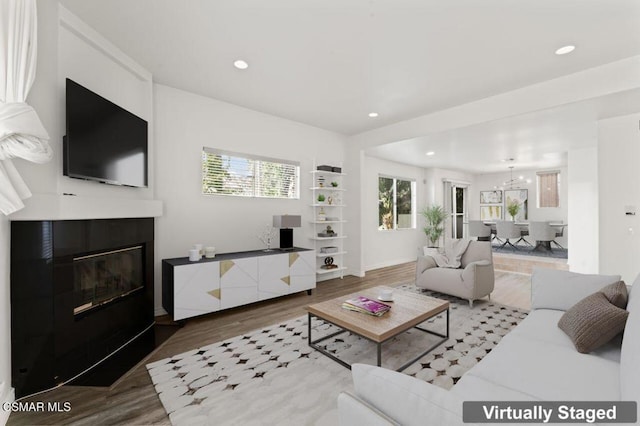 living room featuring hardwood / wood-style flooring and a notable chandelier