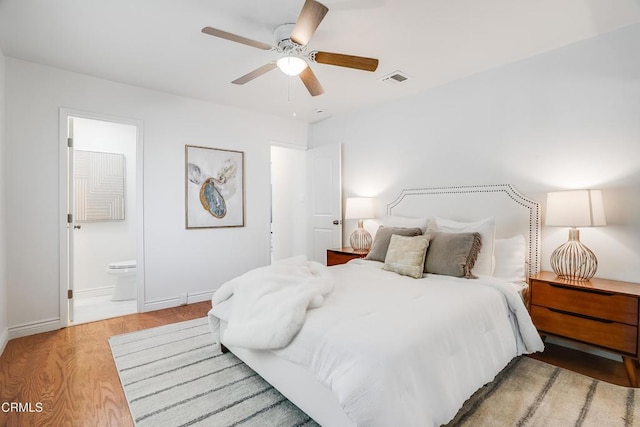 bedroom featuring ceiling fan, connected bathroom, and light wood-type flooring