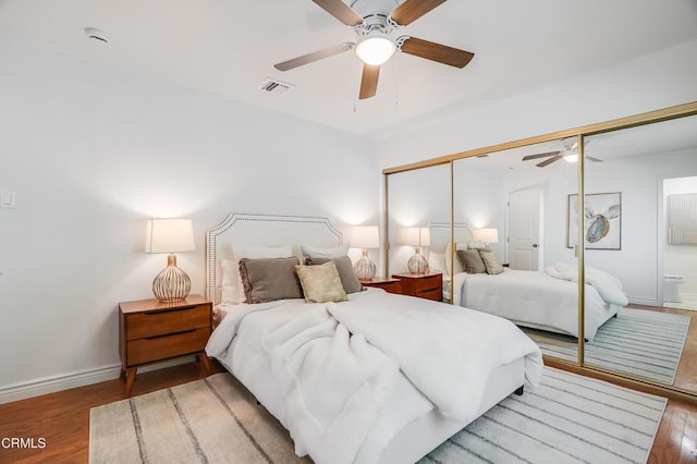 bedroom with ceiling fan, a closet, and hardwood / wood-style floors