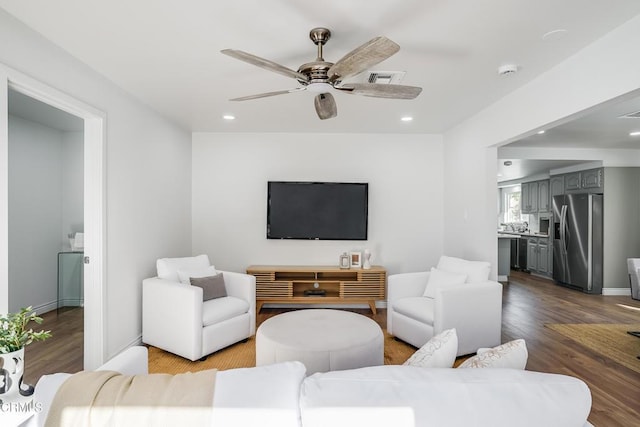 living room featuring ceiling fan and light hardwood / wood-style floors