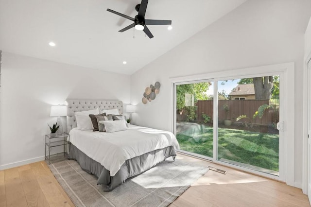 bedroom with ceiling fan, light hardwood / wood-style floors, access to exterior, and high vaulted ceiling