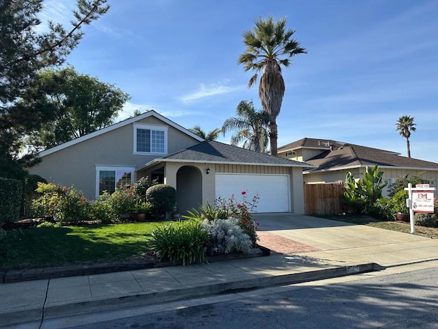 view of front of property with a front lawn and a garage