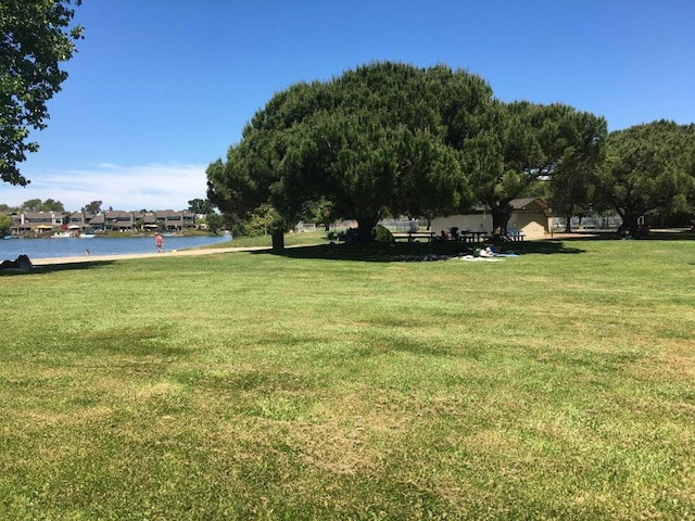 view of home's community featuring a yard and a water view