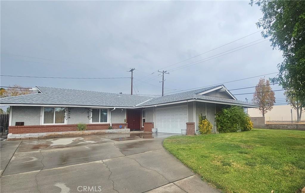 single story home with a front yard and a garage