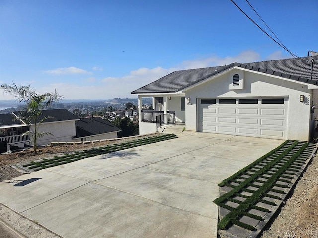 single story home with a porch and a garage