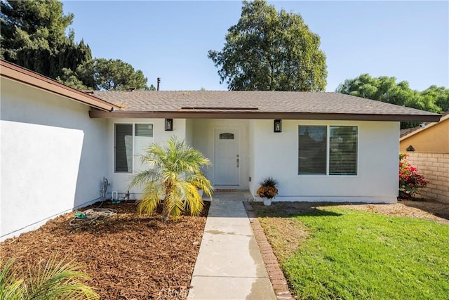 entrance to property with a yard