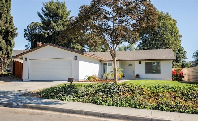 single story home featuring a front yard and a garage