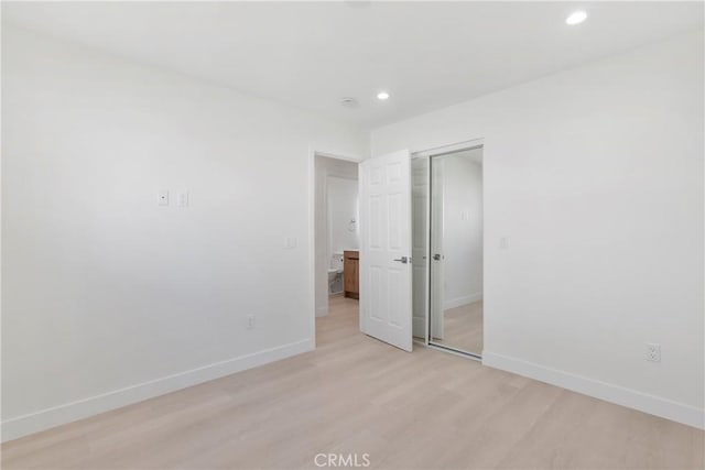 spare room featuring light hardwood / wood-style floors