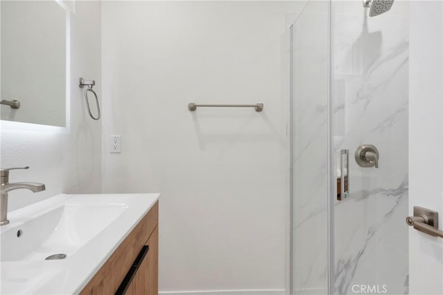 bathroom with walk in shower and vanity