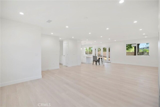 unfurnished living room featuring light hardwood / wood-style flooring