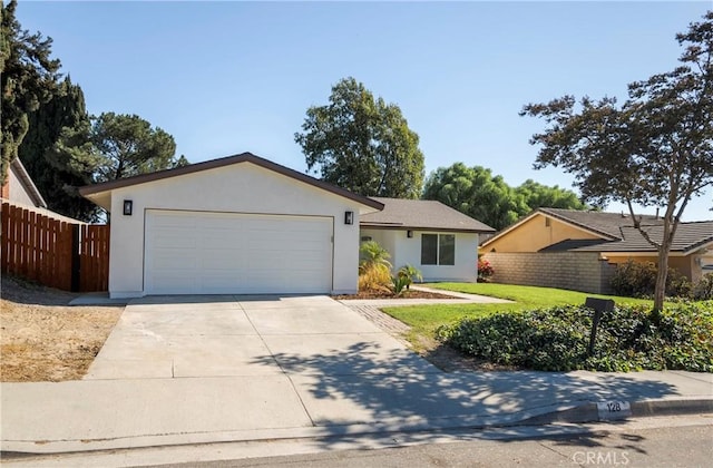 ranch-style house featuring a front yard and a garage