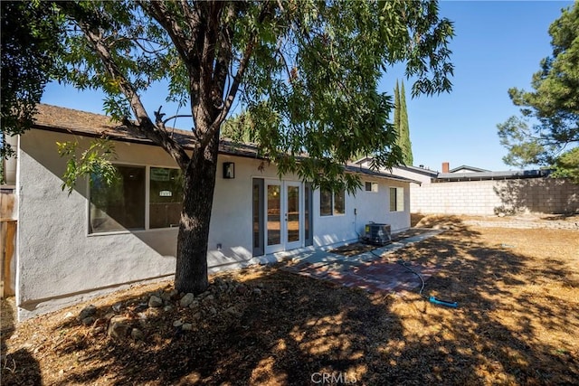 back of house featuring central AC unit