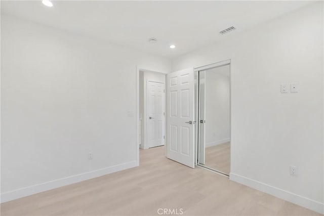 empty room with light hardwood / wood-style floors