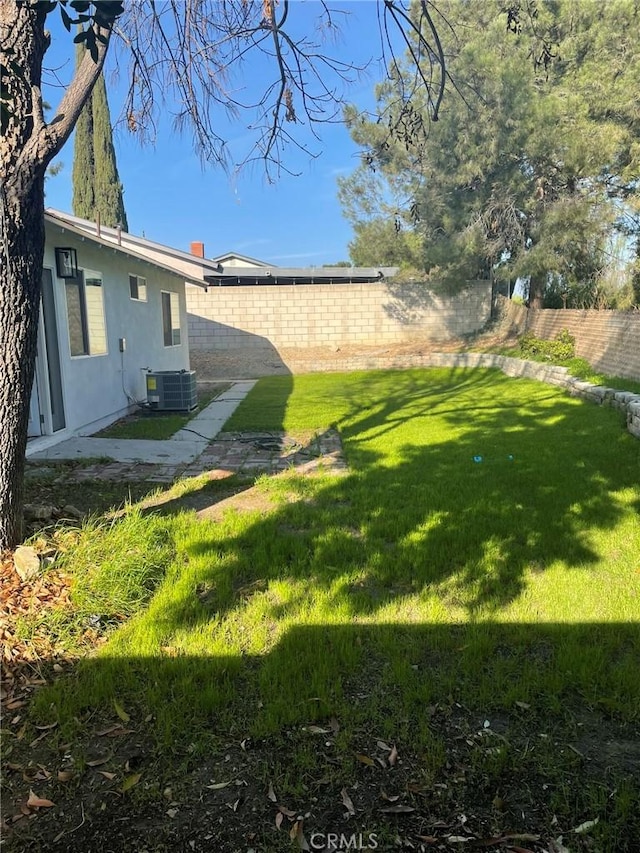 view of yard with central AC unit